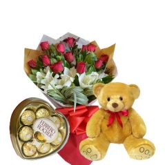 red roses with lilies in a bouquet with
